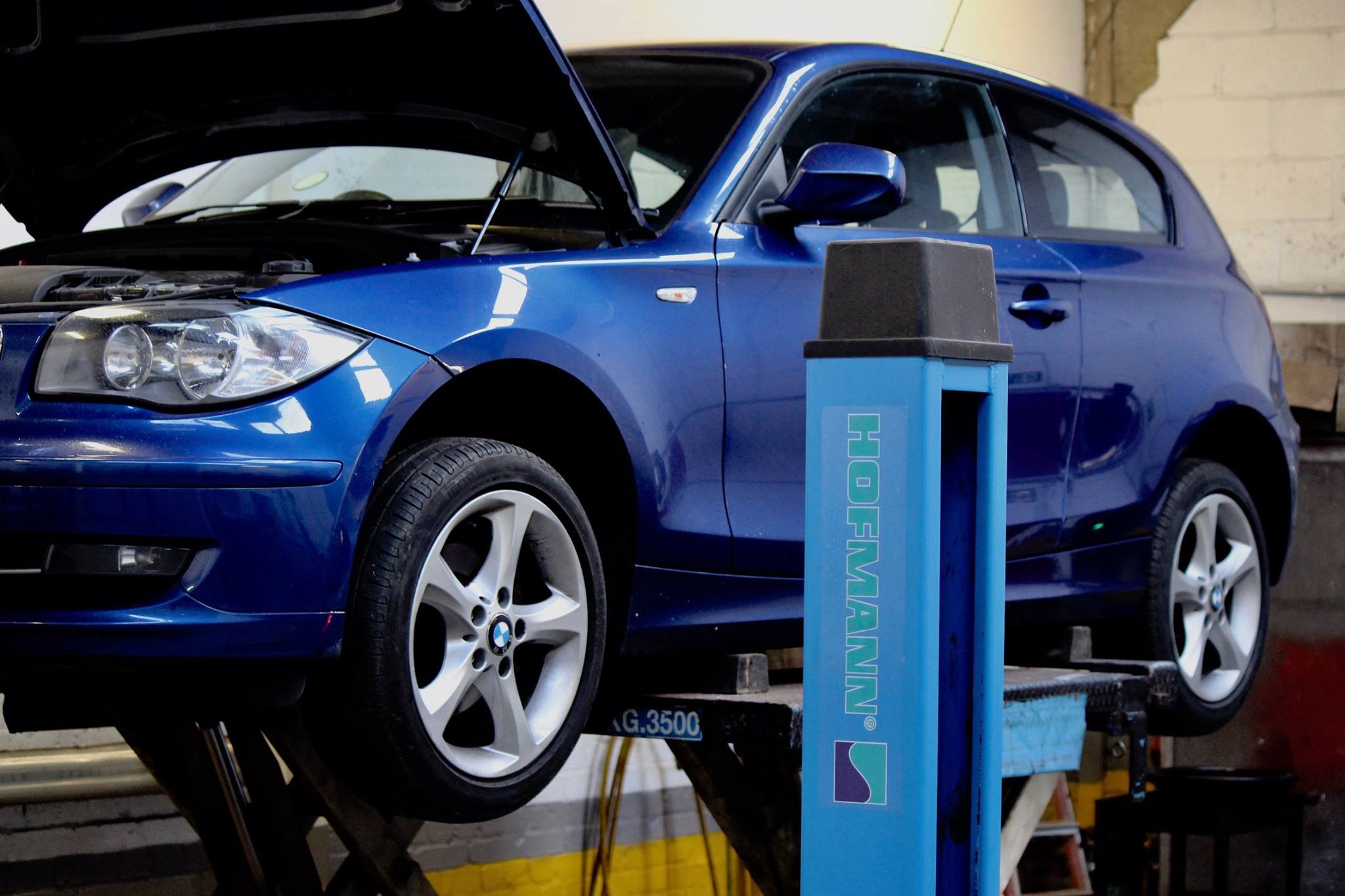 Cambourne Auto Services friendly local workshop bay with technician working on customer vehicle